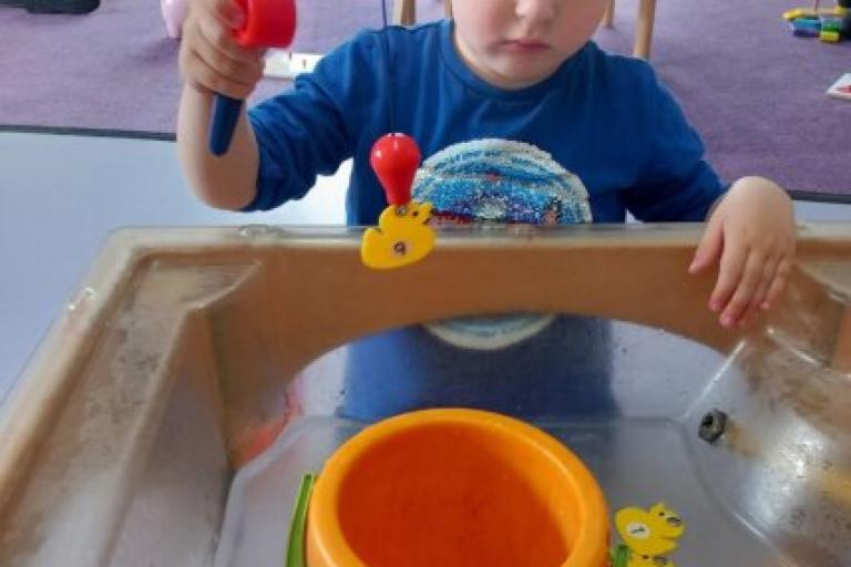 little boy playing in sand