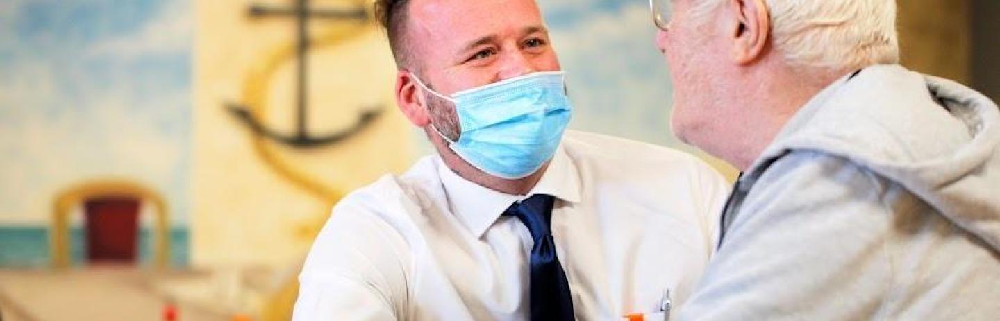 Two adults in a care home having a conversation