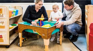 Parents and child playing in the sand