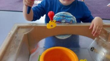 little boy playing in sand